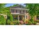 Charming brick home with a welcoming front porch, lush landscaping, and classic architectural details at 2043 Mason Mill Rd, Decatur, GA 30033
