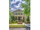 Inviting brick home with a covered porch, detailed landscaping, and well-maintained lawn at 2043 Mason Mill Rd, Decatur, GA 30033