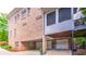 Multi-car garage beneath a brick home with second-story deck at 2043 Mason Mill Rd, Decatur, GA 30033