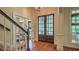 Elegant foyer showcasing hardwood floors, wooden double doors, and bright natural light from the large window at 2043 Mason Mill Rd, Decatur, GA 30033