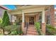 Charming covered front porch with rocking chair and beautiful brickwork at 2043 Mason Mill Rd, Decatur, GA 30033
