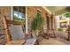 Inviting brick front porch with rocking chairs and a decorative potted plant, creating a cozy entrance at 2043 Mason Mill Rd, Decatur, GA 30033