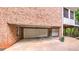 Brick house with a multi-car garage on a paved driveway at 2043 Mason Mill Rd, Decatur, GA 30033