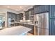 Well lit kitchen with stainless steel appliances, gray cabinets, and marble countertops at 2043 Mason Mill Rd, Decatur, GA 30033