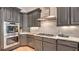 This kitchen features built-in stainless steel appliances, custom gray cabinetry, and light countertops at 2043 Mason Mill Rd, Decatur, GA 30033