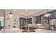 The kitchen features a large island with pendant lighting, stainless steel appliances, and gray cabinets for ample storage space at 2043 Mason Mill Rd, Decatur, GA 30033