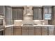 A modern kitchen features gray cabinets, light countertops, and stainless steel appliances, with stylish hardware and accents at 2043 Mason Mill Rd, Decatur, GA 30033