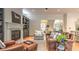 A well-lit living room features a fireplace, built-in shelving, and an open floor plan, with access to the kitchen and a view outside at 2043 Mason Mill Rd, Decatur, GA 30033