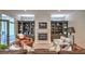 Inviting living room featuring built-in bookshelves, a fireplace, and comfortable seating, with a door leading to the outside at 2043 Mason Mill Rd, Decatur, GA 30033
