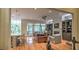 Open concept living room with hardwood floors, fireplace, built-in bookcases and access to the outside at 2043 Mason Mill Rd, Decatur, GA 30033