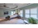 Spacious main bedroom featuring a tray ceiling, fan, and a sitting area with comfortable chairs at 2043 Mason Mill Rd, Decatur, GA 30033