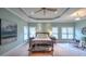 Spacious main bedroom featuring a tray ceiling, fan, and a sitting area with comfortable chairs at 2043 Mason Mill Rd, Decatur, GA 30033