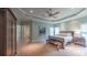 Spacious main bedroom featuring a tray ceiling, fan, and a sitting area with comfortable chairs at 2043 Mason Mill Rd, Decatur, GA 30033
