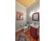 Elegant powder room with vintage decor, custom vanity, and wood flooring at 2043 Mason Mill Rd, Decatur, GA 30033