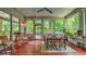 Cozy screened porch with wooden floors and views of the surrounding nature at 2043 Mason Mill Rd, Decatur, GA 30033