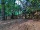 Fenced backyard with mature trees, offering privacy and a serene outdoor experience at 2160 Towne Manor Nw Dr, Kennesaw, GA 30144
