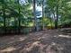 Fenced backyard lined with mature trees, offering privacy and shade for outdoor activities at 2160 Towne Manor Nw Dr, Kennesaw, GA 30144