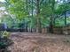 The backyard includes a wood fence and mature trees at 2160 Towne Manor Nw Dr, Kennesaw, GA 30144