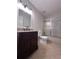 Cozy bathroom features a granite vanity, tiled floors, and a bathtub with sliding glass doors at 2160 Towne Manor Nw Dr, Kennesaw, GA 30144