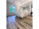 Bedroom features stylish flooring, large window, and mirrored closet at 2160 Towne Manor Nw Dr, Kennesaw, GA 30144