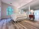 Bedroom features stylish flooring, large window, and mirrored closet at 2160 Towne Manor Nw Dr, Kennesaw, GA 30144