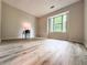 Bright bedroom with large window and wood-look flooring creates a peaceful and inviting space at 2160 Towne Manor Nw Dr, Kennesaw, GA 30144