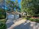 Charming single-story home with a two-car garage, landscaped front yard, and a driveway at 2160 Towne Manor Nw Dr, Kennesaw, GA 30144