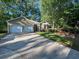 Charming single-story home with a two-car garage, landscaped front yard, and a driveway at 2160 Towne Manor Nw Dr, Kennesaw, GA 30144
