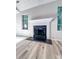 Cozy fireplace with classic white mantle, flanked by bright windows at 2160 Towne Manor Nw Dr, Kennesaw, GA 30144