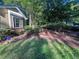 Well-maintained front yard with blooming rose bushes and lawn, enhancing curb appeal and charm at 2160 Towne Manor Nw Dr, Kennesaw, GA 30144