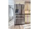 Kitchen features stainless steel refrigerator, granite countertops, and white cabinets at 2160 Towne Manor Nw Dr, Kennesaw, GA 30144