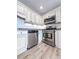 Kitchen features stainless steel appliances, granite countertops, and white cabinets at 2160 Towne Manor Nw Dr, Kennesaw, GA 30144