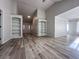Open concept living area with built-in shelving and luxury vinyl plank flooring at 2160 Towne Manor Nw Dr, Kennesaw, GA 30144