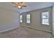 Carpeted bedroom featuring neutral walls, a ceiling fan and three bright windows at 4120 Buckley Woods Dr, Norcross, GA 30093