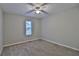 Cozy bedroom featuring carpet, a ceiling fan and a bright window at 4120 Buckley Woods Dr, Norcross, GA 30093