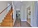 Inviting entryway featuring hardwood floors, staircase with wooden banister, and views into the living room and kitchen at 4120 Buckley Woods Dr, Norcross, GA 30093
