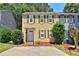 Charming two-story home with yellow siding, green shutters, and a well-manicured front yard at 4120 Buckley Woods Dr, Norcross, GA 30093