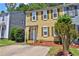 Two-story townhouse with yellow siding, green shutters, and a well-maintained front lawn and landscaped yard at 4120 Buckley Woods Dr, Norcross, GA 30093
