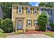 Charming two-story home with yellow siding, green shutters, and a well-manicured front yard at 4120 Buckley Woods Dr, Norcross, GA 30093