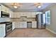 Bright eat-in kitchen featuring stainless steel appliances, white cabinets, and ceramic tile flooring at 4120 Buckley Woods Dr, Norcross, GA 30093