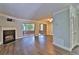 Cozy living room with sleek dark floors, fireplace, and sliding door access to the outdoor space at 4120 Buckley Woods Dr, Norcross, GA 30093