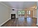 Bright living room with fireplace, hardwood floors, and sliding doors to sunroom at 4120 Buckley Woods Dr, Norcross, GA 30093