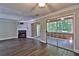 Open living room features hardwood floors, fireplace, and sliding doors to sunroom at 4120 Buckley Woods Dr, Norcross, GA 30093