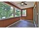 Enclosed sunroom featuring wood paneling, vinyl floors and an abundance of natural light from the large picture windows at 4120 Buckley Woods Dr, Norcross, GA 30093