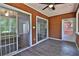 Enclosed sunroom features ample light, gray plank flooring, and doors leading to living area at 4120 Buckley Woods Dr, Norcross, GA 30093