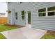 The back patio has grey siding, white trim, and a concrete slab perfect for entertaining at 174 Bloomfield Cir, Canton, GA 30114