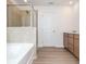 Bathroom featuring a bathtub, shower, and double vanity at 174 Bloomfield Cir, Canton, GA 30114