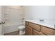 A well-lit bathroom featuring a shower-tub, toilet, and vanity with light wood cabinets and a bright white countertop at 174 Bloomfield Cir, Canton, GA 30114