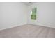 A bright bedroom with a plush carpet and a window overlooking the trees at 174 Bloomfield Cir, Canton, GA 30114
