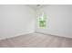 A bright bedroom with a plush carpet and a window overlooking the trees at 174 Bloomfield Cir, Canton, GA 30114